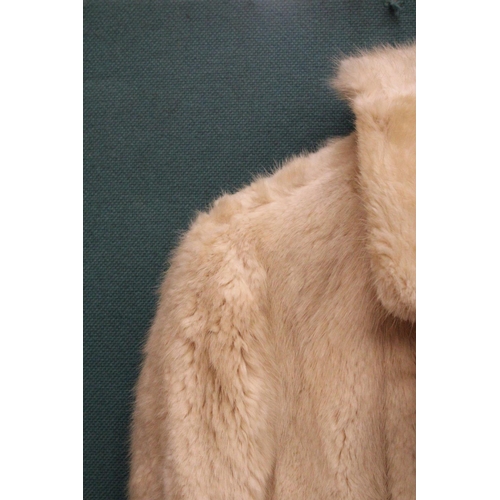 86 - A CREAM COLORED FUR JACKET