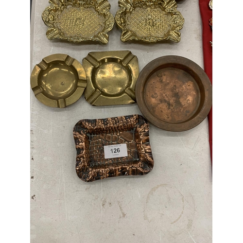 126 - A COLLECTION OF BRASS AND COPPER ASHTRAYS