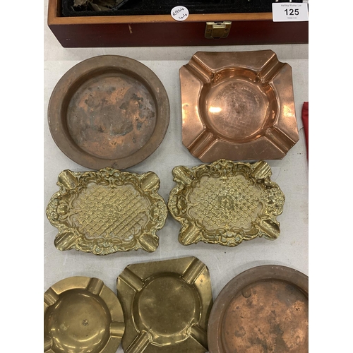 126 - A COLLECTION OF BRASS AND COPPER ASHTRAYS