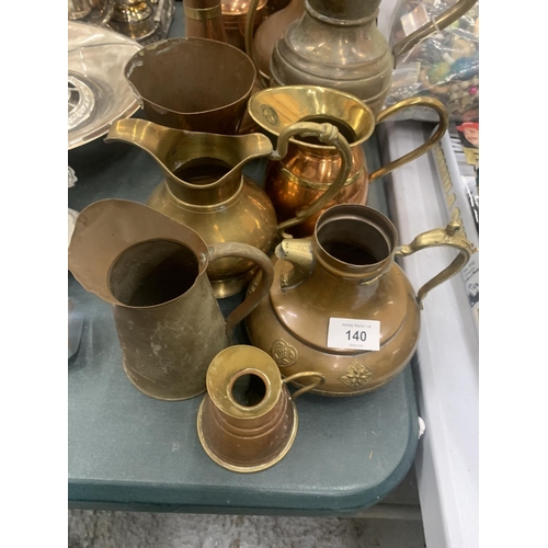 140 - A LARGE COLLECTION OF BRASS AND COPPER JUGS