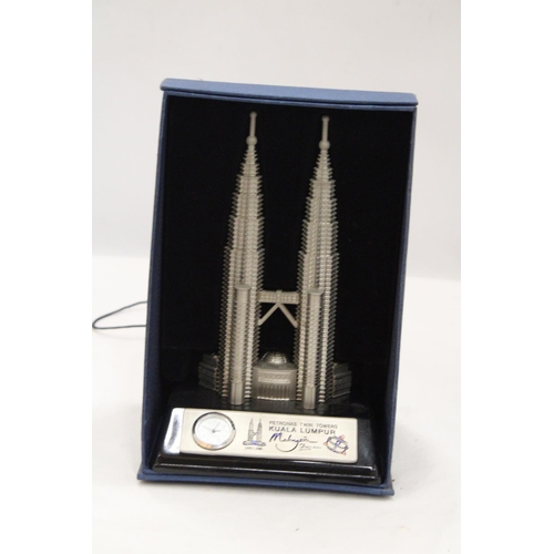 218 - A BOXED, SOLID PEWTER, PETRONASTOWERS CLOCK, HEIGHT 21CM