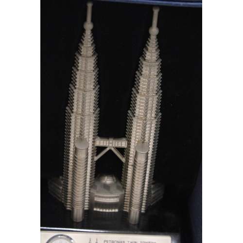 218 - A BOXED, SOLID PEWTER, PETRONASTOWERS CLOCK, HEIGHT 21CM