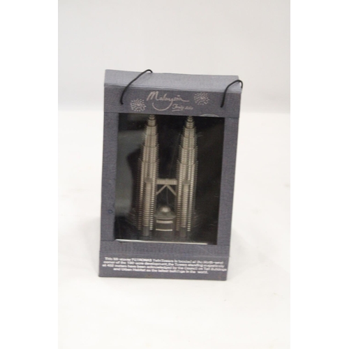 218 - A BOXED, SOLID PEWTER, PETRONASTOWERS CLOCK, HEIGHT 21CM