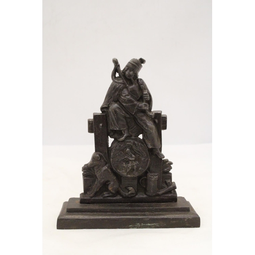 229 - A HEAVY CAST BAG-PIPER AND DOG DOORSTOP ON PEDESTAL