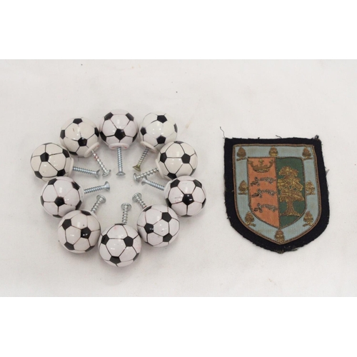 233 - A 1930'S EMBROIDED BADGE PLUS TEN FIFA FOOTBALL DRAWER KNOBS