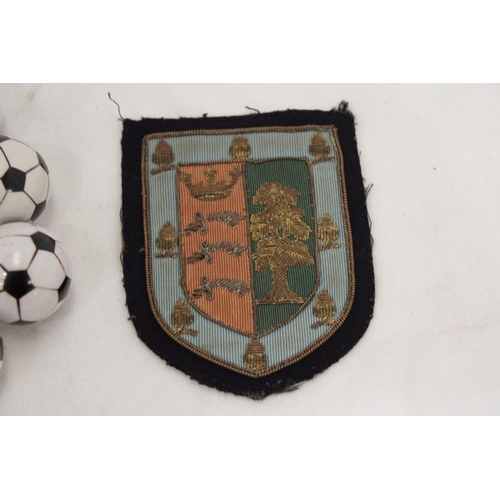 233 - A 1930'S EMBROIDED BADGE PLUS TEN FIFA FOOTBALL DRAWER KNOBS