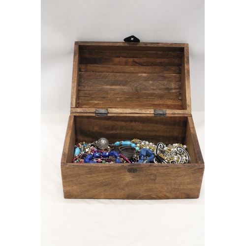 250 - A LARGE WOODEN CHEST FILLED WITH COSTUME JEWELLERY