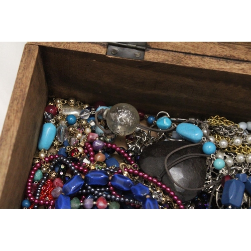 250 - A LARGE WOODEN CHEST FILLED WITH COSTUME JEWELLERY