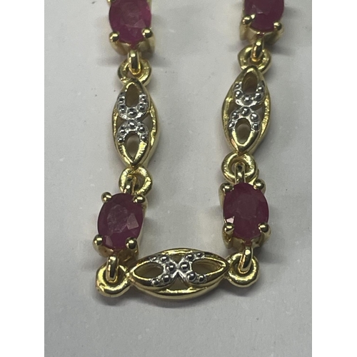 551 - AN 18 CARAT GOLD PLATED BRACELET WITH PINK AND CLEAR STONES