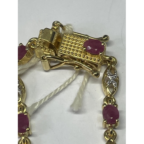 551 - AN 18 CARAT GOLD PLATED BRACELET WITH PINK AND CLEAR STONES