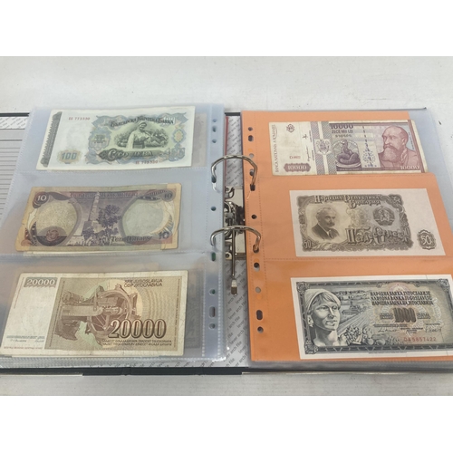 323 - AN ALBUM CONTAINING 69 DOUBLE SIDED WALLETS OF VINTAGE WORLD BANK NOTES TO INCLUDE CAMBODIAN BANK NO... 