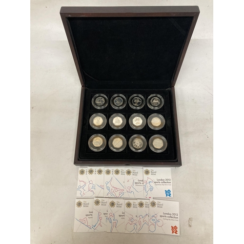 340 - A MAHOGANY COIN BOX CONTAINING TWELVE ROYAL MINT 2012 OLYMPIC SILVER 50P COINS TO INCLUDE AQUATICS, ... 