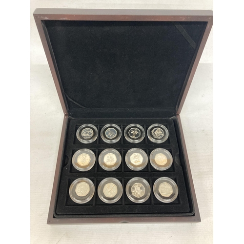 340 - A MAHOGANY COIN BOX CONTAINING TWELVE ROYAL MINT 2012 OLYMPIC SILVER 50P COINS TO INCLUDE AQUATICS, ... 