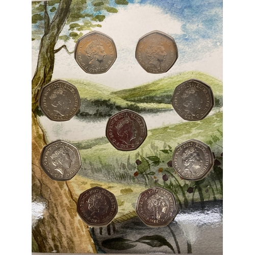 392 - A COLLECTION OF COLLECTOR'S FIFTY PENCE COIN PACKAGES TO INCLUDE ROYAL MINT BEATRIX POTTER PETER RAB... 