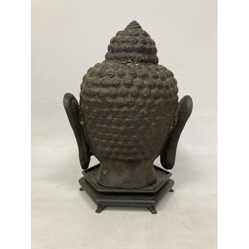 11 - A LARGE BRASS BUDDHA HEAD WITH A BRONZE FINISH ON WOODEN STAND (POSSIBLY 1950'S)