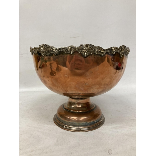 29 - A LARGE HEAVY VICTORIAN COPPER DECORATED BOWL ON A PLINTH WITH A PAIR OF HEAVY COPPER CANDLESTICKS