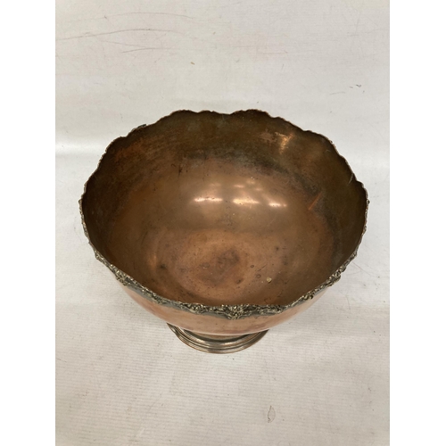 29 - A LARGE HEAVY VICTORIAN COPPER DECORATED BOWL ON A PLINTH WITH A PAIR OF HEAVY COPPER CANDLESTICKS