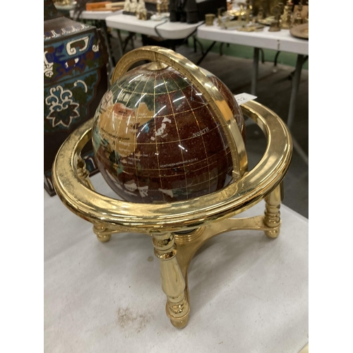 212 - A GEMSTONE GLOBE WITH A COMPASS TO THE BASE