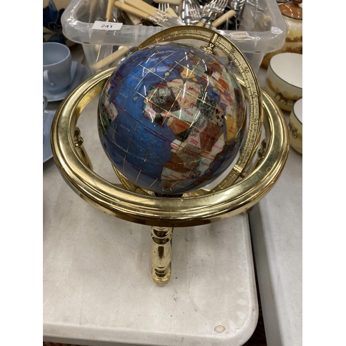 242 - A GEMSTONE GLOBE WITH COMPASS TO THE BASE