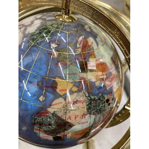 242 - A GEMSTONE GLOBE WITH COMPASS TO THE BASE