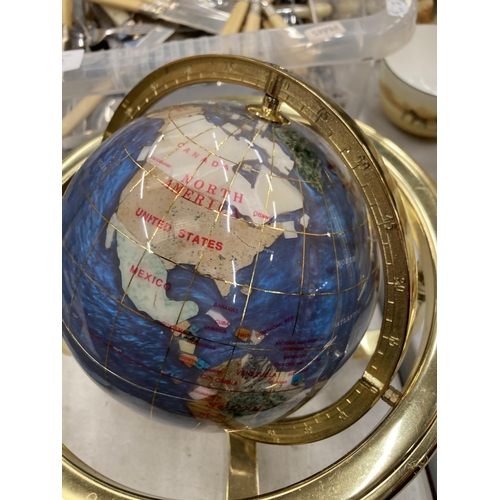 242 - A GEMSTONE GLOBE WITH COMPASS TO THE BASE