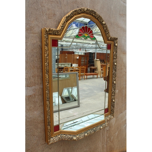 2825 - A GILT EFFECT WALL MIRROR WITH COLOURED GLASS AND MIRRORED SHELF, 35