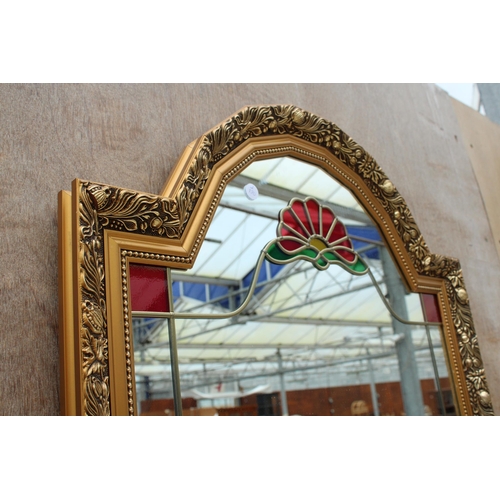 2825 - A GILT EFFECT WALL MIRROR WITH COLOURED GLASS AND MIRRORED SHELF, 35