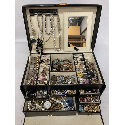 56 - A LARGE QUANTITY OF COSTUME JEWELLERY IN A LEATHERETTE JEWELLERY BOX TO INCLUDE NECKLACES, RINGS, EA... 