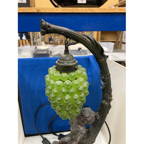 95 - A CAST RESIN FIGURAL TABLE LAMP WITH HANGING GRAPE DECORATION (A/F)