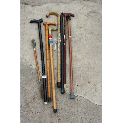 1988 - AN ASSORTMENT OF VARIOUS WALKING STICKS TO INCLUDE ONE WITH A BRASS DUCK HEAD HANDLE ETC