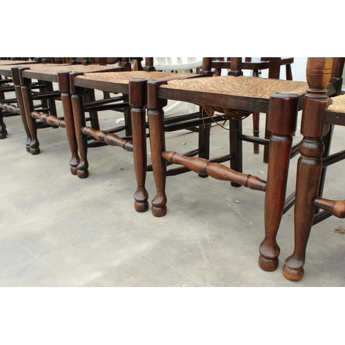 2858 - EIGHT ELM LANCASHIRE STYLE LADDER BACK DINING CHAIRS WITH RUSH SEATS, TWO BEING CARVERS