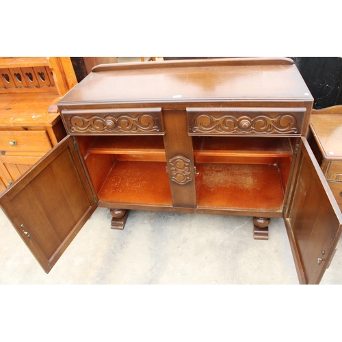 2871 - A MID 20TH CENTURY OAK SIDEBOARD ENCLOSING TWO DRAWERS AND TWO CUPBOARDS, 48