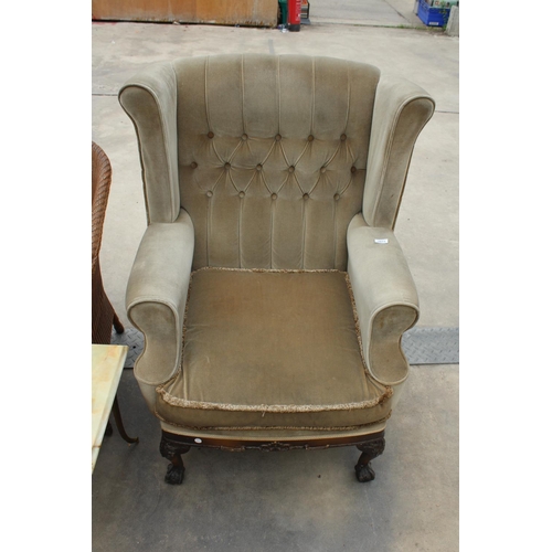 2873 - A HIGH WINGED AND BUTTONED BACK ARMCHAIR ON CARVED MAHOGANY CABRIOLET SUPPORTS