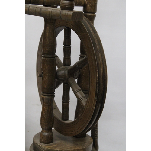 63 - A VINTAGE WOODEN SPINNING WHEEL AND CHAIR