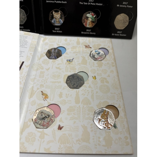 583 - A FIFTY PENCE COIN COLLECTION ALBUMS TO INCLUDE CELEBRATING THE WONDERFUL WORLD OF MISS POTTER (FIVE... 