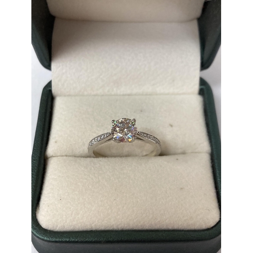 654 - A 925 SILVER SOLITAIRE RING WITH A 1 CARAT MOISSANITE STONE AND MOISSANITE TO THE SHOULDERS SIZE O, ... 