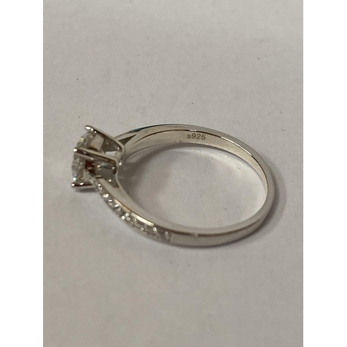 654 - A 925 SILVER SOLITAIRE RING WITH A 1 CARAT MOISSANITE STONE AND MOISSANITE TO THE SHOULDERS SIZE O, ... 