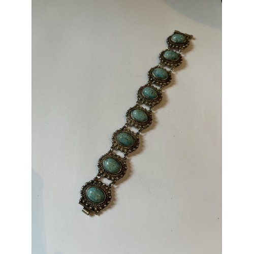 696 - A DECORATIVE MARKED SILVER BRACELET WITH BLUE STONES