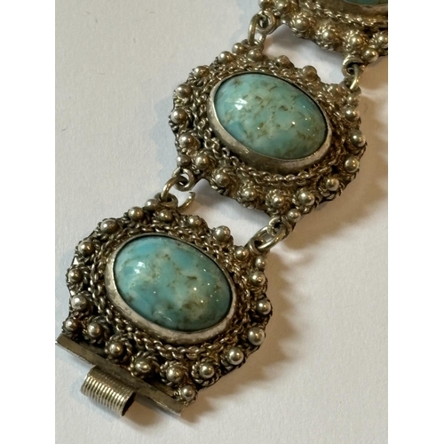 696 - A DECORATIVE MARKED SILVER BRACELET WITH BLUE STONES