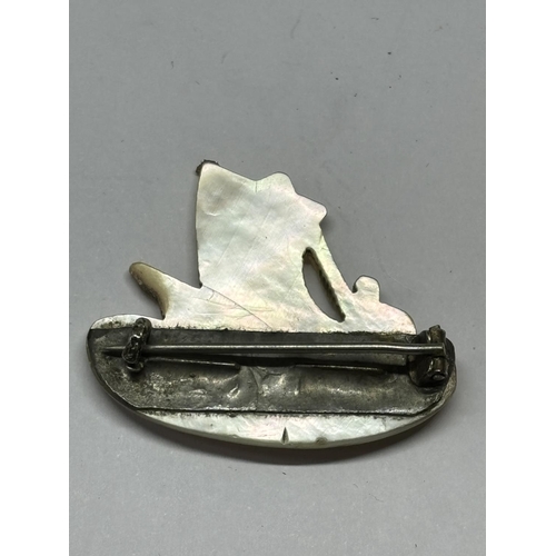 718 - A MOTHER OF PEARL BROOCH IN A SHIP DESIGN