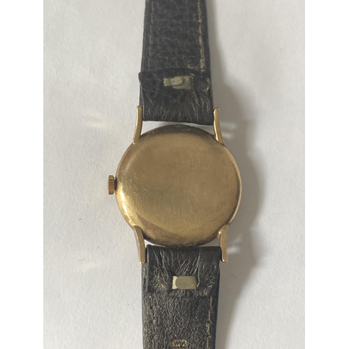 513 - AN EVERITE 9 CARAT GOLD WRISTWATCH WITH BROWN LEATHER STRAP SEEN WORKING BUT NO WARRANTY GIVEN