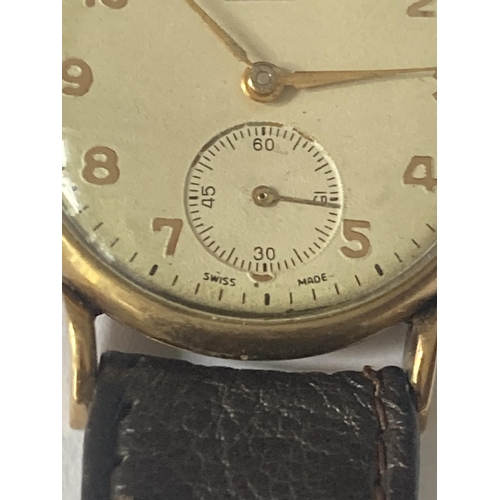 513 - AN EVERITE 9 CARAT GOLD WRISTWATCH WITH BROWN LEATHER STRAP SEEN WORKING BUT NO WARRANTY GIVEN