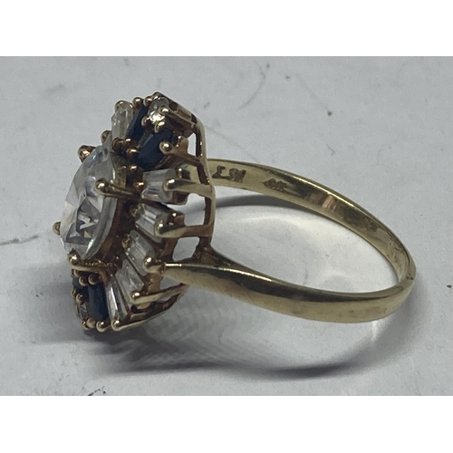 526 - A 14 CARAT DECO STYLE DRESS RING WITH A CENTRE OVAL CLEAR STONE SURROUNDED BY BLUE AND CLEARSTONES S... 