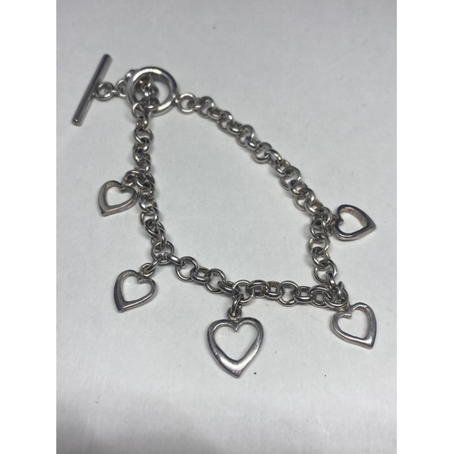 536 - A PAIR OF HEART DESIGN SILVER EARRINGS AND A SILVER CHARM BRACELET WITH FIVE HEARTS IN A PRESENTATIO... 