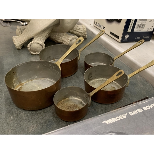 184 - A SET OF FIVE COPPER AND BRASS GRADUATED PANS