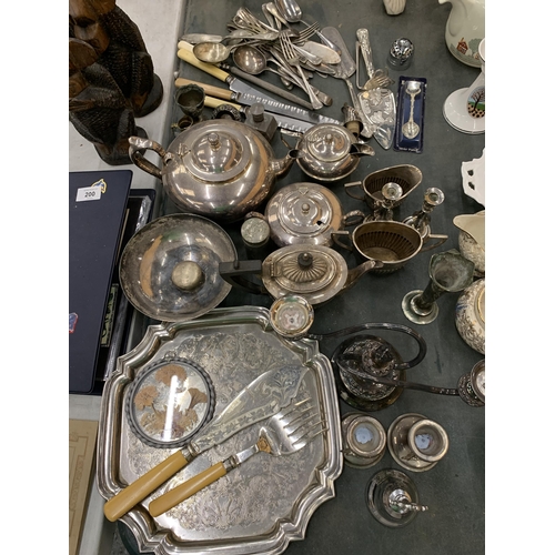 198 - A LARGE QUANTITY OF VINTAGE SILVER PLATE TO INCLUDE TEAPOTS,  JUGS, FLATWARE, CANDLESTICKS, ETC