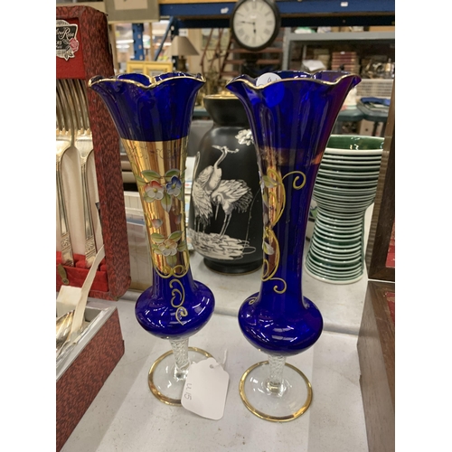 236 - A PAIR OF VINTAGE BOHEMIAN COBALT BLUE GLASS VASES WITH HAND PAINTED FLORAL DECORATION