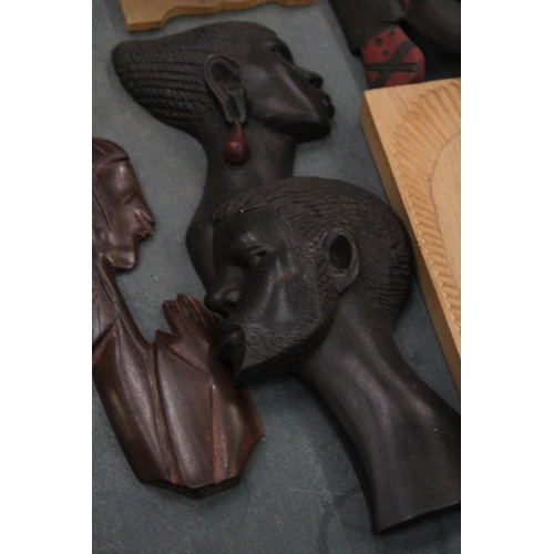 245 - A COLLECTION OF CARVED WOODEN AFRICAN THEMED ITEMS TO INCLUDE WALL MASKS, A PAIR OF SHORT SPEARS, A ... 