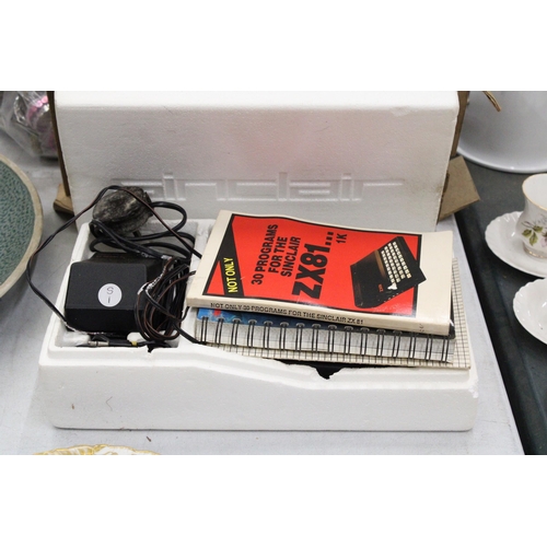 268 - A VINTAGE SINCLAIR ZX81 COMPUTER WITH POWER SUPPLY AND PROGRAMMES IN ORIGINAL BOX