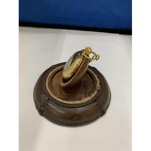 17 - A GOLD PLATED HALF HUNTER POCKET WATCH ON A LEATHER BOUND STAND